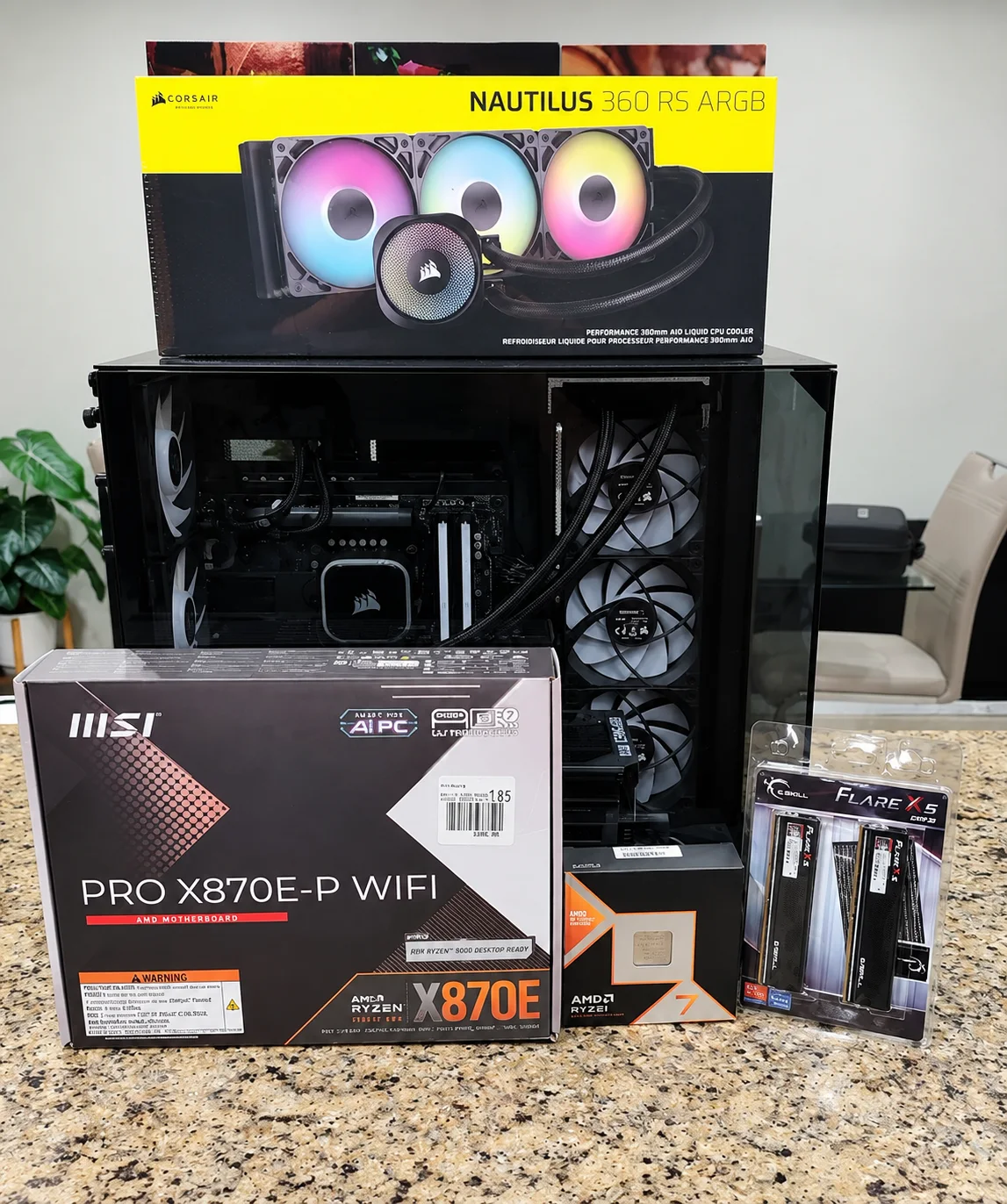 Black PC case displayed with boxes for a motherboard, processor, memory and liquid cooler.
